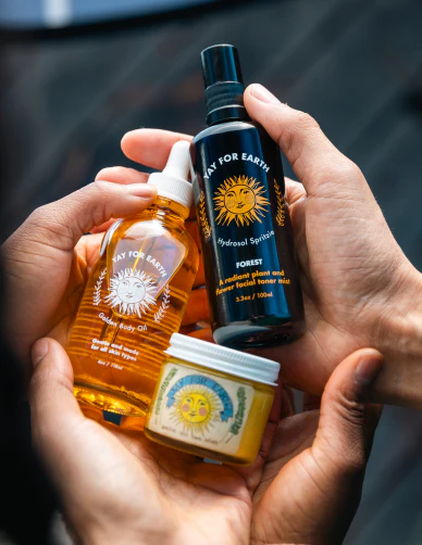 A detail photo of Yay for Earth's small batch skincare, including Golden Body Oil, Sensitive Skin Face Lotion, and Hydrosol Spritzie, made with all natural and organic ingredients for sensitive skin and all skin types.