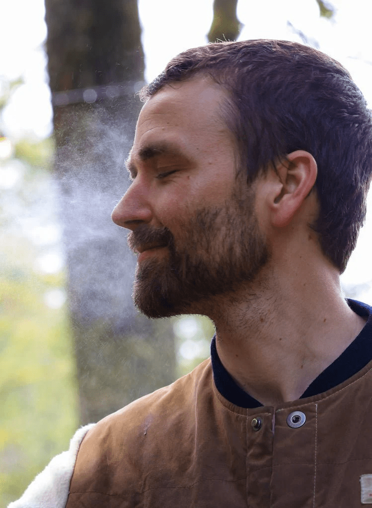 A man uses Yay for Earth's Hydrosol Spritzie, a face toner for men made with steam distilling plants and all organic ingredients.