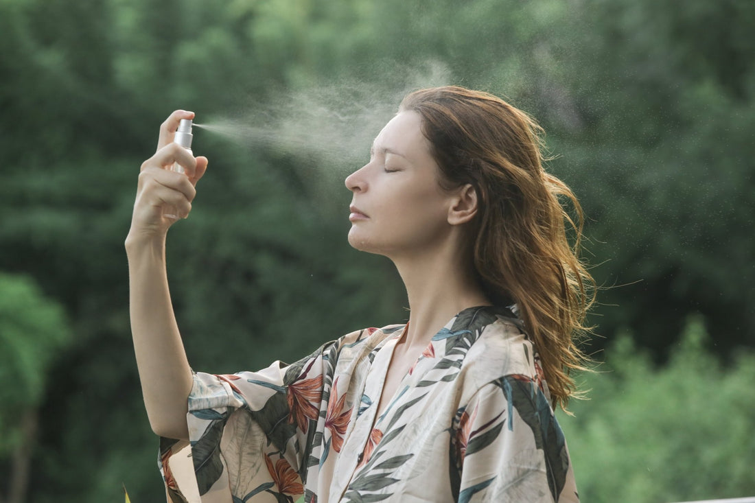 A woman sprays hydrosol on her face. What is a hydrosol? Learn what separates the real from the fake in our complete guide.