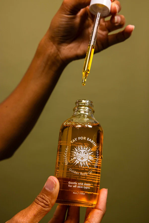 A detail photo of Yay for Earth's Golden Body Oil, an organic face oil that leaves skin soft and glowing and mad with all organic ingredients.